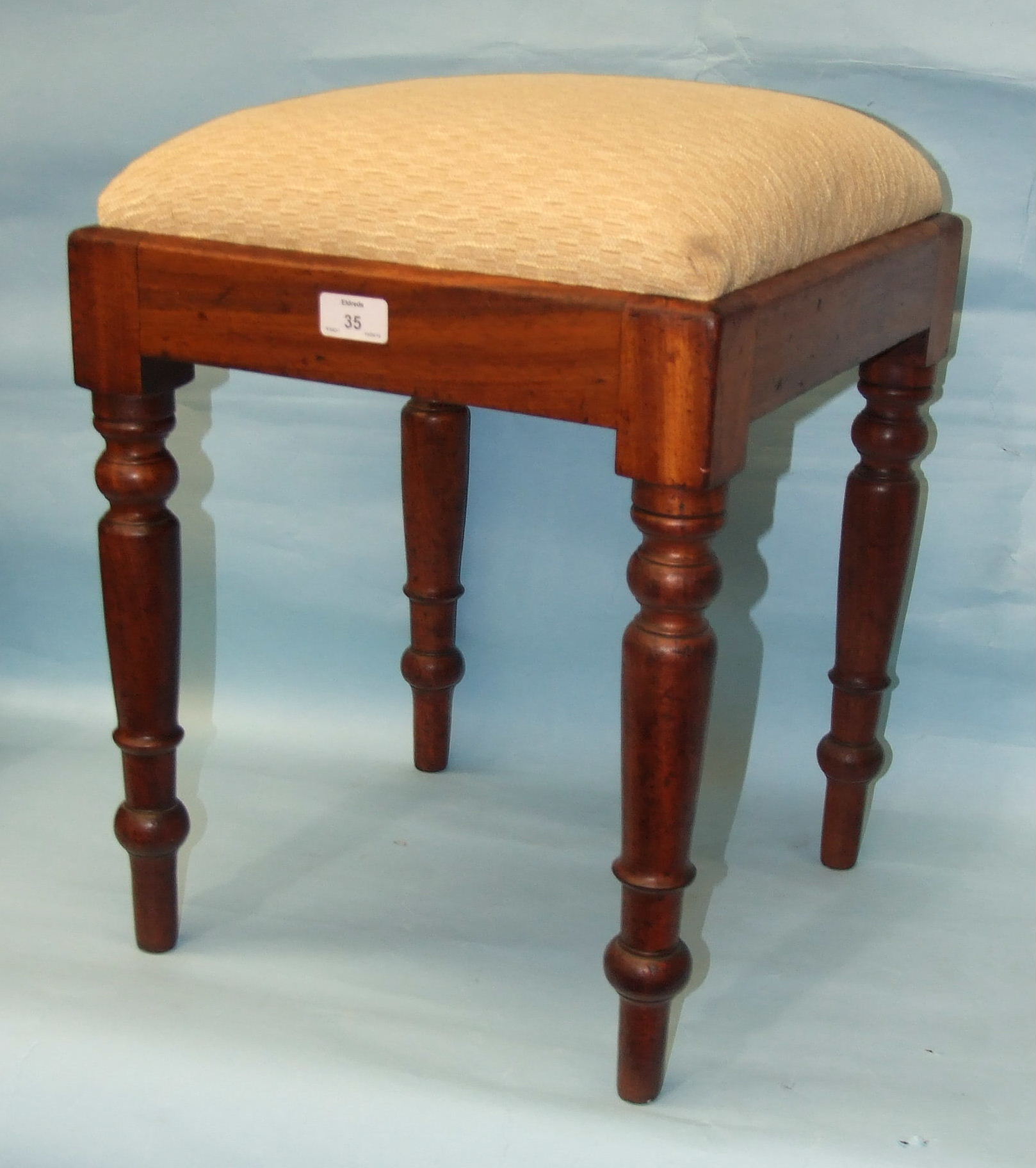 A mahogany square upholstered-seat stool, on turned legs, 37cm square, 48cm high.