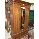 A Victorian mahogany single-door wardrobe, the cornice above a mirror door, on base drawer, 120cm