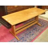 A 1970's hardwood adjustable-height coffee table of shaped oblong form, 122 x 51cm.