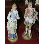 A pair of Continental bisque figures of a Gallant wearing a flowery waistcoat and his companion,