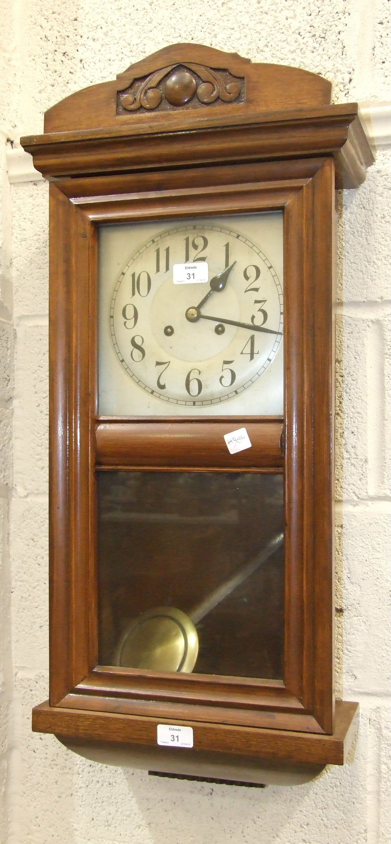 An oak case striking wall clock, 80cm high.