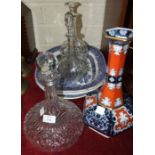 A cut glass ship's decanter and stopper, 28cm, two other glass decanters, a ceramic hexagonal-shaped