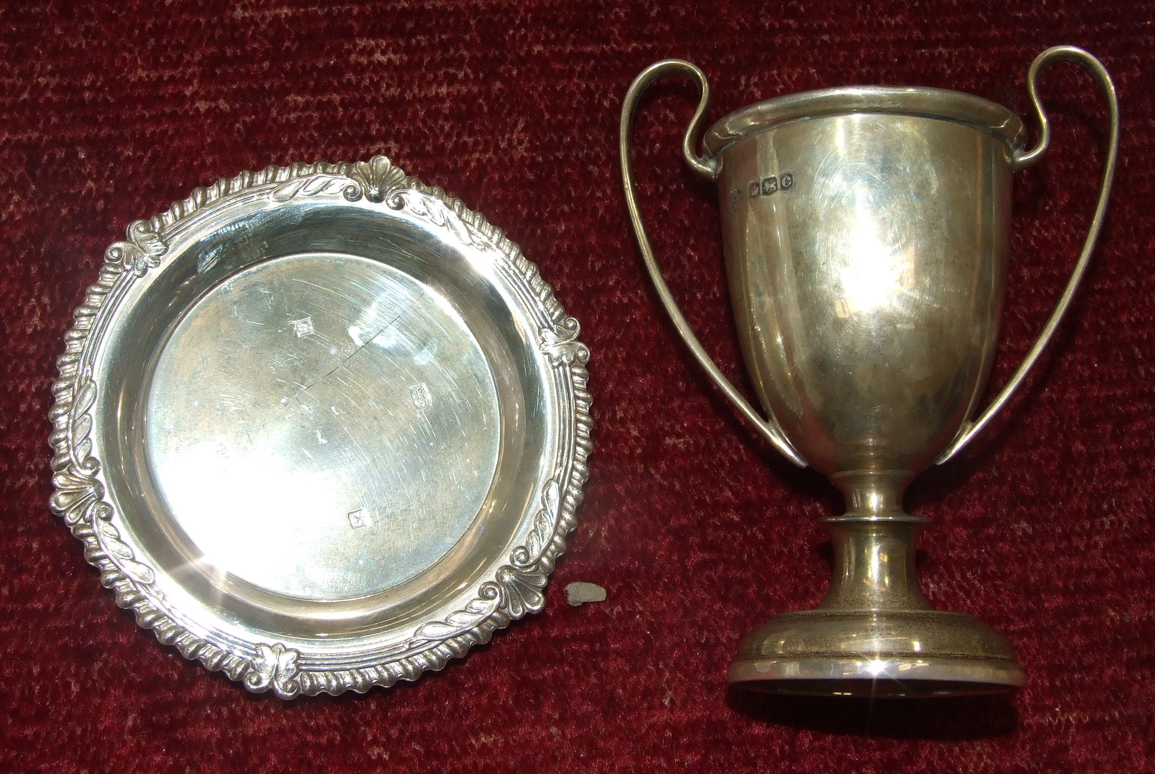 A small silver trophy cup, Sheffield 1920, 11cm high and a modern silver small circular pin tray,