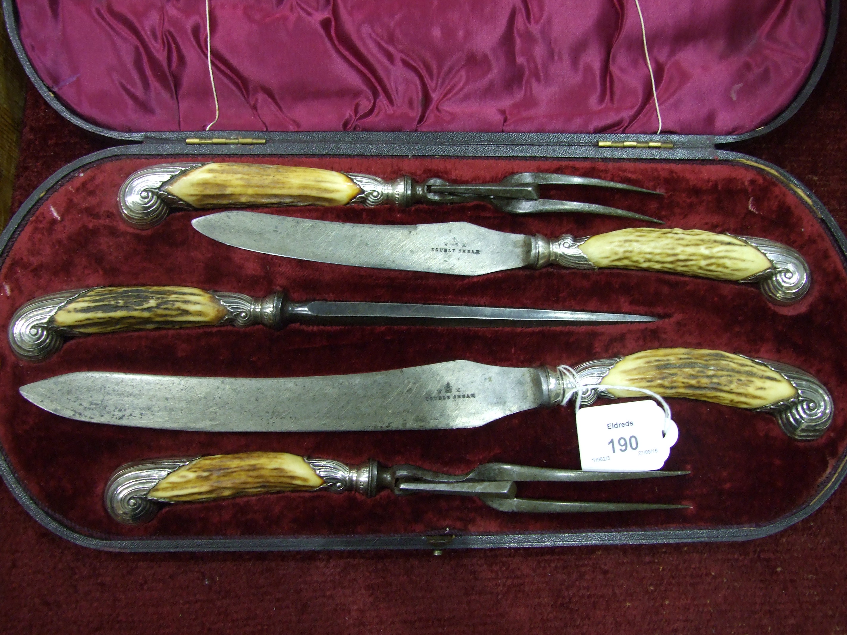 A Walker & Hall horn-handled stainless steel five-piece carving set with silver collars and scroll