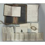 A leather wallet containing a letter dated 1829 and a lock of Lady Harriet Eliot's hair, a newspaper