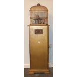 A 20th century bird automaton on stand with coin-operated electric mechanism, the metal cage with