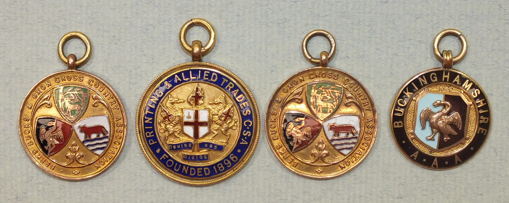 Four 9ct gold athletics medals with enamelled decoration, awarded to Mr G W Johnson, 38g, (4).