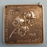 A silver square medallion commemorating 50 years of "Le Caire Congres International du Coton" 1901-
