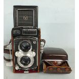 A Yashica-Mat E M twin lens camera with Yashinon 1:3.2 f:80 and 1:3.5 f:80 lenses, in leather case