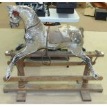 A late Victorian painted wood and gesso rocking horse, raised on central stretcher rocker, 112cm