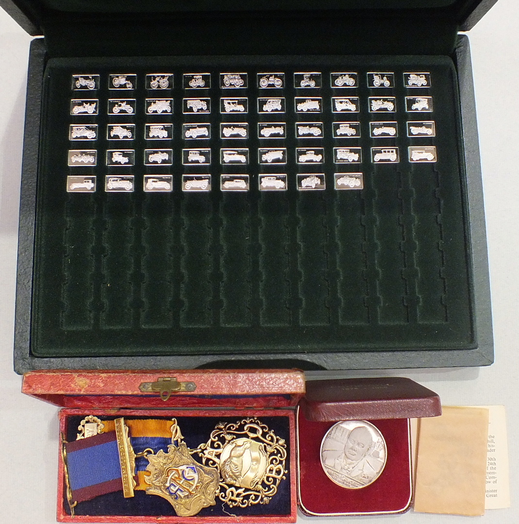 A part-set of forty-eight silver ingots depicting classic cars, approximately ___2.4oz, in case, two