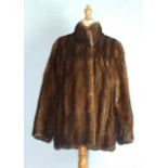 A dark brown mink fur jacket with stand-up collar, approximately size 12, three fur stoles, a mink