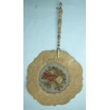 A pressed card fan with petit point panel and turned gilt wood handle, 25cm diammeter (af), and a