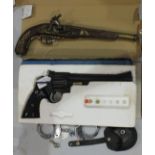 Two replica revolvers, a replica antique pistol and a pair of handcuffs, (4).