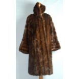 A brown mink fur coat with wide collar and lapels, size 10/12.