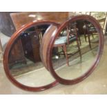 Two stained wood circular framed wall mirrors, (2).