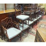 A collection of seventeen bamboo-effect carved wood chairs, including eleven carver chairs, (17).