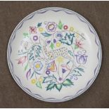 A Poole Pottery circular wall plaque, the centre decorated with stylised fruit, 32.5cm diameter, a