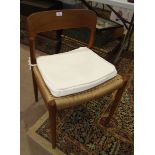 A set of four J L Moller teak dining chairs, (seats in need of restoration), a thistle-carved