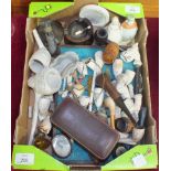 A collection of clay pipes, wood pipes and smoking accessories.