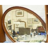 An inlaid mahogany oval framed wall mirror, 70 x 100cm.