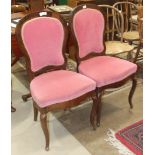 A pair of 19th century French rosewood dining chairs with upholstered serpentine seats, on