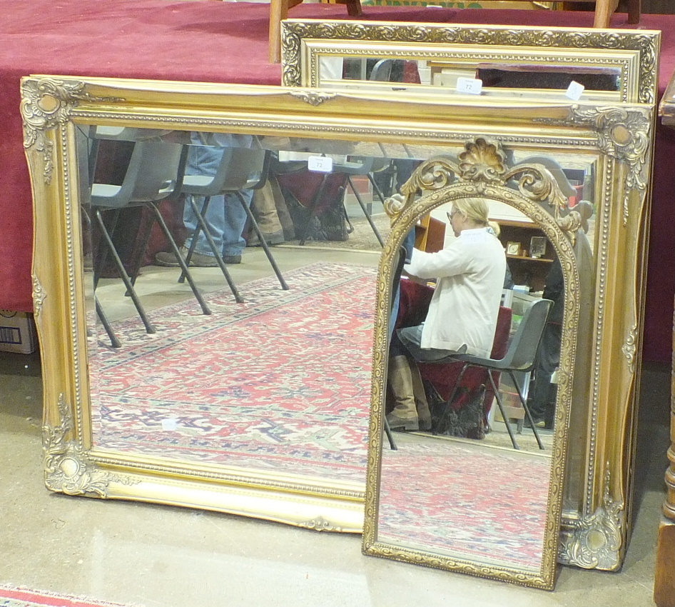 A modern gilt frame hanging wall mirror, 106 x 77cm and two other mirrors, (3).