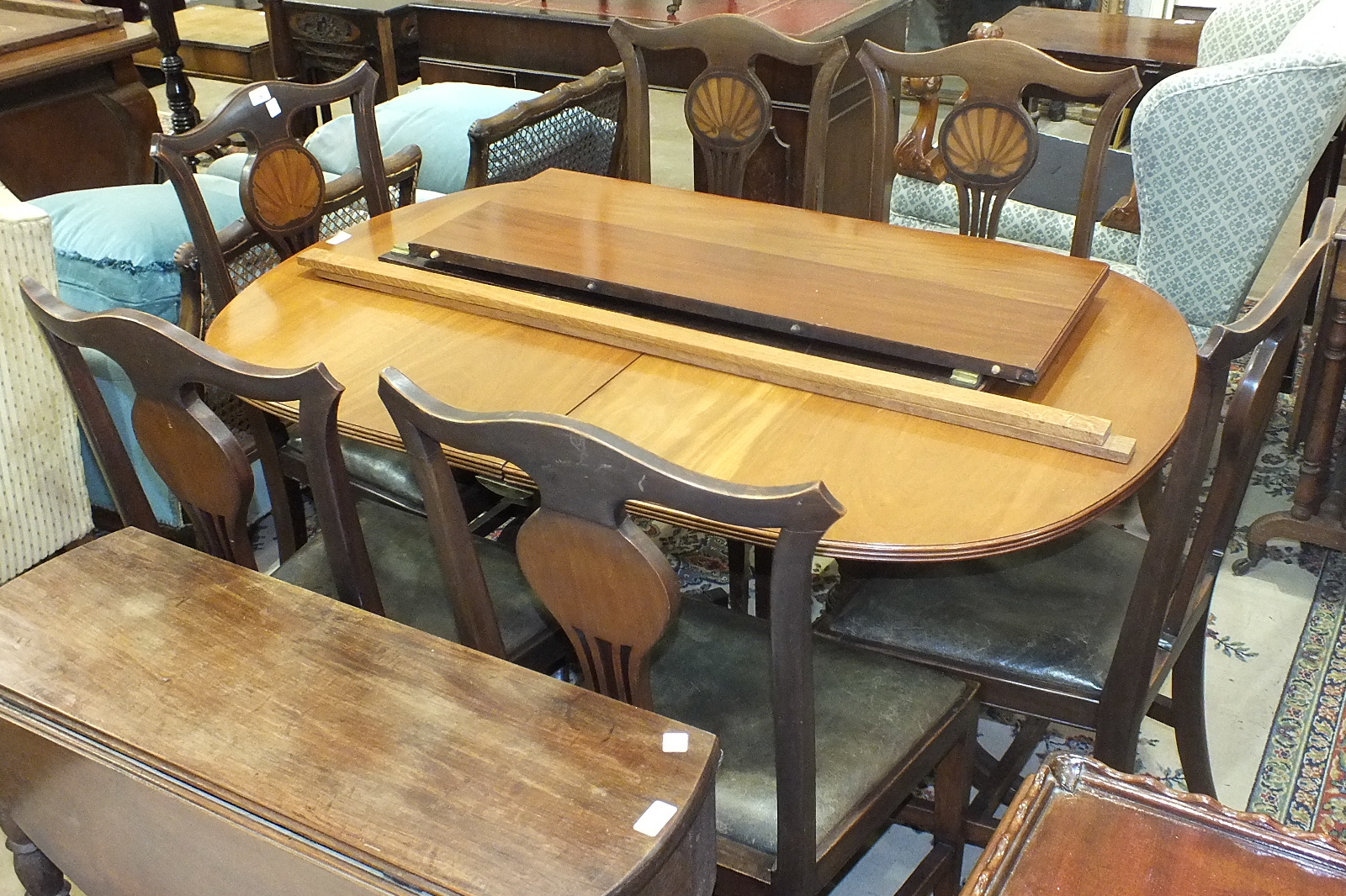 A set of six mahogany high-back dining chairs, each back inlaid with shell motif and a mahogany