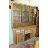 A stripped pine dresser, the top with central leaded light Art Nouveau floral panel and coloured