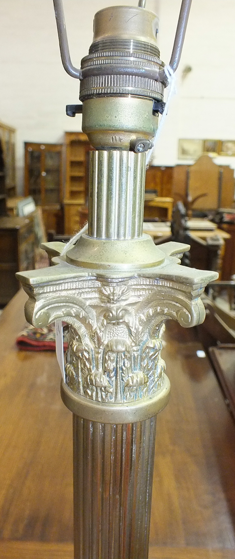 A brass Corinthian column standard lamp on square marble and brass base with claw feet, 148cm high.