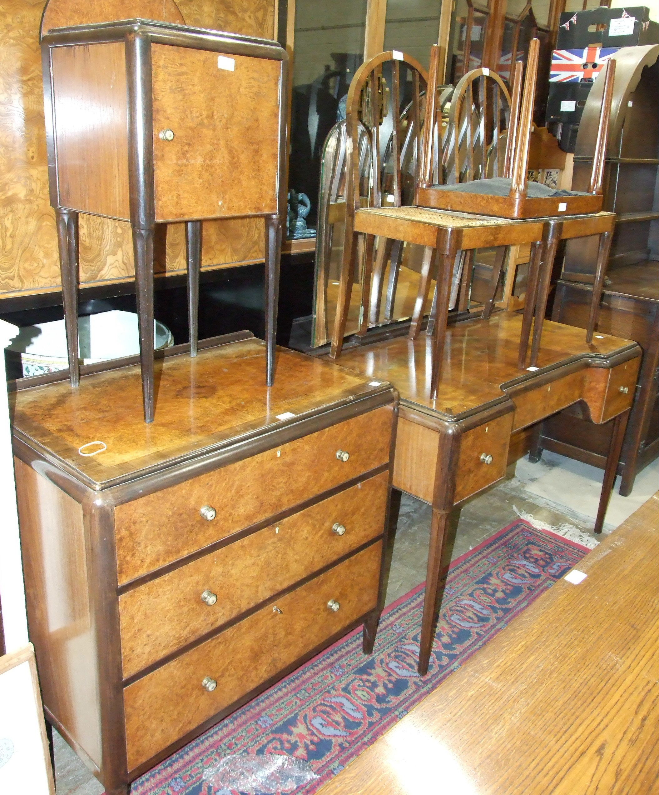 A Bath Furniture Company bedroom part-suite of cross-banded burr walnut, comprising: a three-