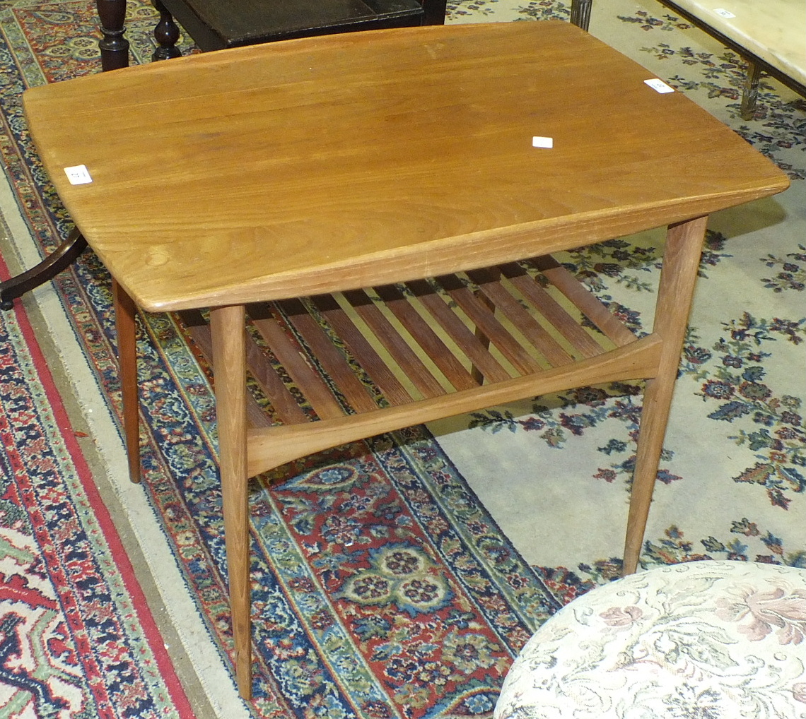 A France & Sons teak occasional table of rectangular form, on tapering shaped legs joined by a