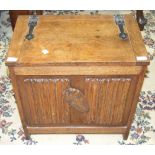 A small oak chest with hinged lid and linen-fold decorated panel front, 55.5cm wide, 56cm high.