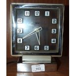 A Smiths electric clock with chromium-plated frame and square dial, 20cm high, 16cm wide and an