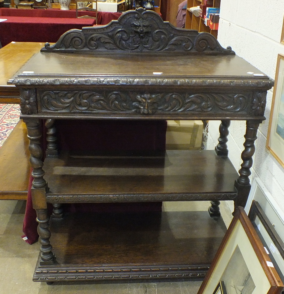 A Victorian carved oak three-tier buffet fitted with frieze drawer, 105cm wide, 107cm high.