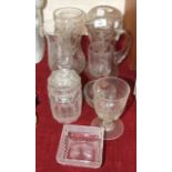 A collection of various glassware, including wine and drinking glasses, vases, jugs, etc.