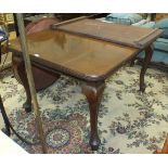 A 20th century mahogany extending dining table on cabriole legs, (with extra leaf) and a walnut