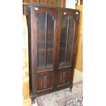 An oak glazed bookcase, 77cm wide, 152cm high.