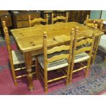 A modern pine rectangular-top kitchen table on turned legs, 141 x 83cm, a set of six pine ladder-