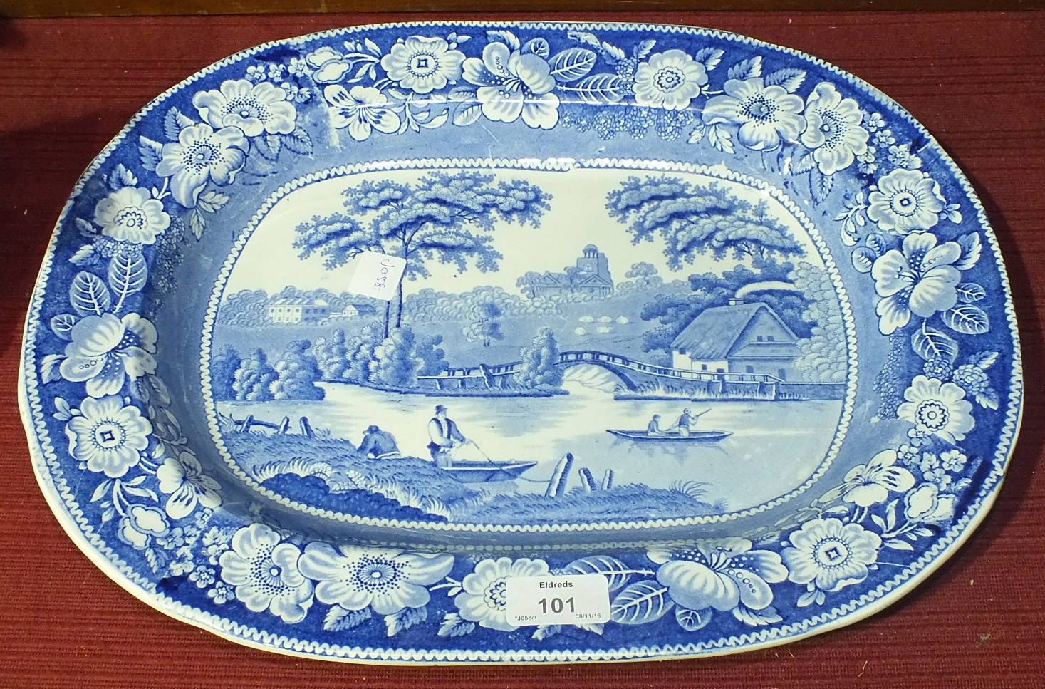 A late-19th century blue and white meat plate in the 'Wild Rose' pattern with river landscape,
