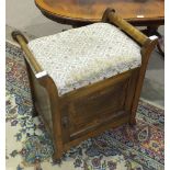 An Edwardian stained wood music stool, the upholstered seat above a single door opening to reveal
