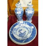 A pair of Oriental blue and white vases and covers decorated with a dragon amongst foliage, marks to