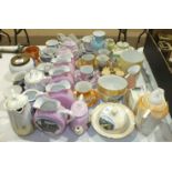 A collection of late-19th/early-20th century ceramic souvenir ware, including pink lustre jugs and