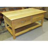 A modern light wood TV unit with two drawers and base shelf, 110cm wide, 50cm high, 59cm deep.