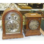 An oak-cased chiming bracket clock with slow/fast, chime/silent and carrying handle, 34cm high and