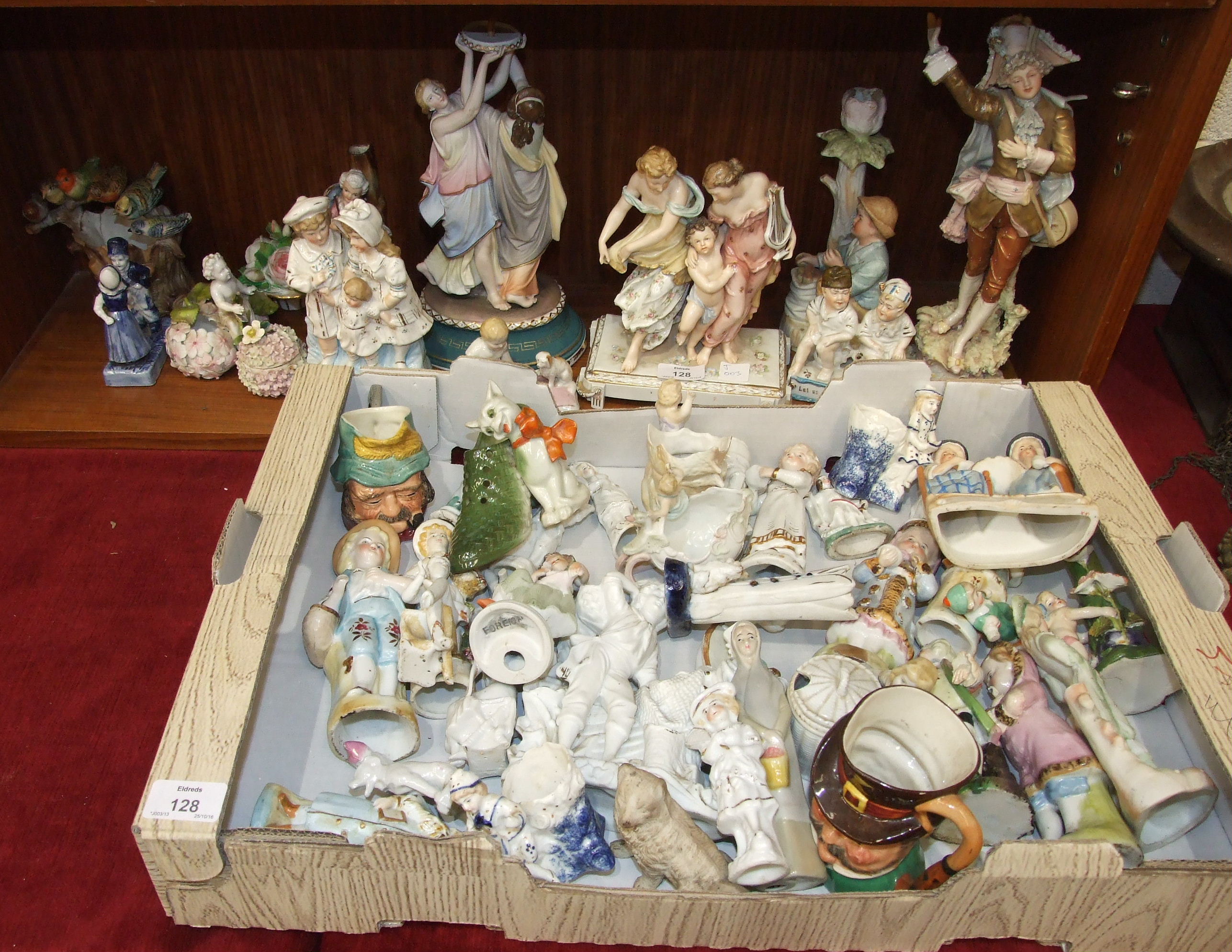 A collection of late-19th and 20th century ceramic and bisque figure ornaments, many damaged.