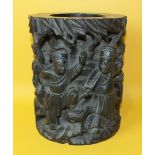 An Oriental carved wood brush pot decorated in relief with figures and trees, 16cm diameter, 20cm