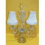 A late-Victorian cut glass two-branch candelabrum with lustre drops, on circular base, 54cm high, (