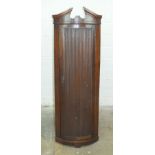 An antique oak corner cupboard of small proportions, 37cm wide, 111cm high.