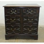 An antique oak chest of three drawers applied with mouldings, on bracket feet, 82cm wide, 82cm